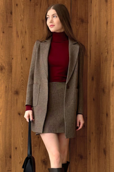 a lady in a red sweater, a coffee brown coat and a coffee brown wool skirt